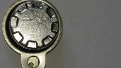 Termostat KSD301 z oznaczeniem 110/60 na metalowej obudowie