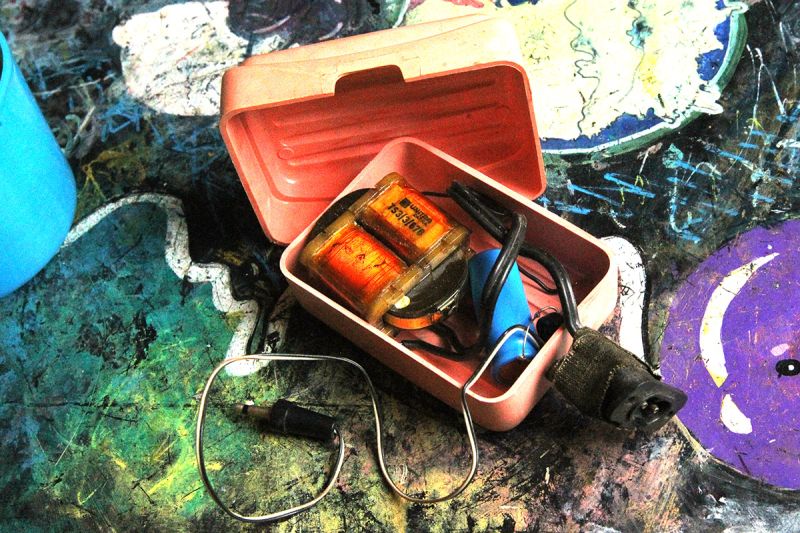 DIY power supply in a pink plastic case with transformers and tangled wires