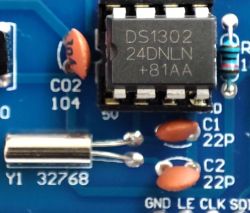 Close-up of a PCB with DS1302 IC, 32768 crystal, and 22 pF capacitors C1 and C2