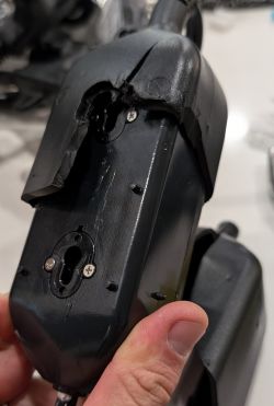 Device Housing with Visible Screws Unscrewed device housing with visible screws.