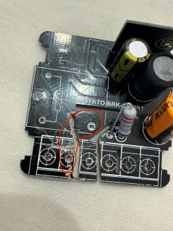 Printed circuit board with damaged connection marked in red.