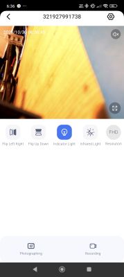 Distorted camera view showing wires and a wooden surface.