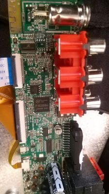 Image of a circuit board of an electronic device with visible markings and connectors.