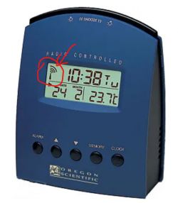 Oregon Scientific radio-controlled clock with an LCD display showing time, date, and temperature, with a highlighted signal indicator.