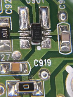 Macro of a green PCB with an SMD chip, traces, solder pads, and the printed label “C919”