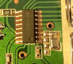 Close-up of an electronic circuit featuring chip 3-DOTG15-J2M and a 24.000MHz crystal.