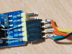Close-up of a USB-TTL module with attached wires.