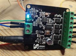 Close-up of an electronic circuit board with visible components and a lit LED.