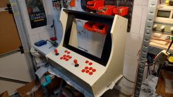 Bartop Arcade Machine in Progress Homemade bartop arcade machine with red buttons and joysticks on a white background.