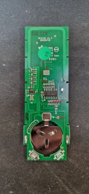 PCB with electronic components and a battery holder.
