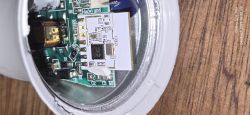 Inside an LED bulb showing a PCB with a white Wi‑Fi module labeled “CB2L”
