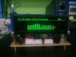 LCD screen showing a radio station name and animated sound bar visualization
