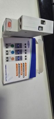 TOMZN circuit breaker and packaging on a light-colored surface