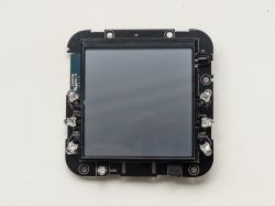 Front view of a PCB with a large LCD display and LEDs arranged around the edges.