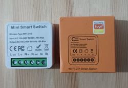 Two boxes with a Wi-Fi smart switch on a table.