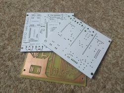 Three PCBs on a carpet: two white boards and one copper board, labeled “ESP32 Web Radio” with many holes.