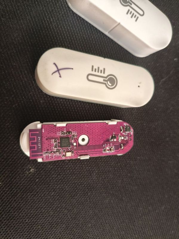 Interior of Zigbee sensor with exposed purple PCB and electronic components