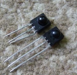 Two black infrared receivers on a fuzzy surface.