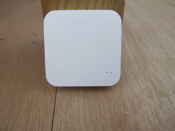 White square sensor on a wooden surface.