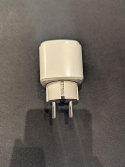 Travel Adapter with Plug Travel adapter with two pins on a dark background.