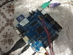 PCB board with various ports and cables on a table with bubble wrap.