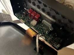 Close-up of a radio's interior showing a circuit board and capacitors.