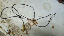 Black cable with a USB-A plug and a yellow RCA connector on a dirty work surface