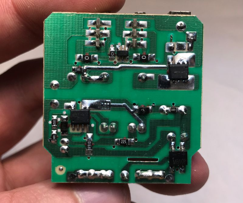 Power supply PCB with visible ICs, resistors, and solder joints.
