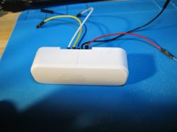 Modified Temperature and Humidity Sensor Temperature and humidity sensor with connected wires on a blue mat background.