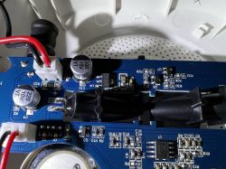Blue PCB in Smoke Detector Close-up of a blue PCB with electronic components in an optical smoke detector.