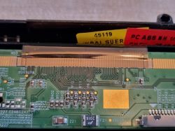 Close-up of a driver board with connected FFC cable.