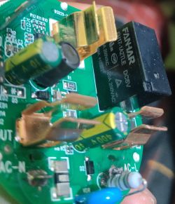 Close-up of a circuit board with a FANHAR relay and other electronic components.