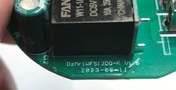 Close-up of electronic components on green PCB with FANHAR relay