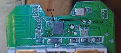 Close-up of a PCB section with four pins on the right and two SMD components next to one pin.
