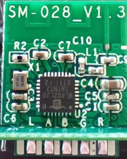 Close-up of a green printed circuit board with electronic components.