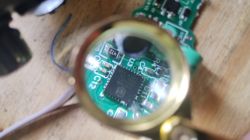 Image of a circuit board viewed through a magnifying glass.
