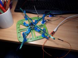 Home setup with an electronics board and clamps on a desk.