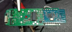 Circuit board with desoldered MCU module and connected wires.