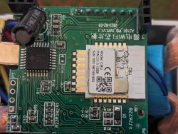 Close-up of a circuit board with electronic components, including capacitors and an integrated circuit.