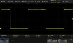 Oscilloscope screen showing a rectangular waveform with amplitude 5.03958 V and frequency 10.001214 kHz.