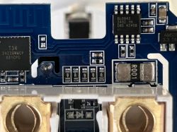 Close-up of a circuit board with electronic components, including a T34 chip.
