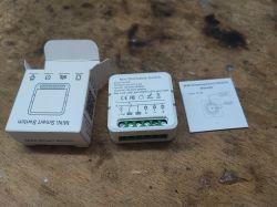 Mini dimmer module FS-05R with packaging and instructions on a wooden table.