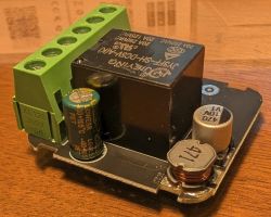Relay module with capacitors and terminal block on a wooden surface