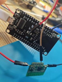 Lolin module and green PCB board connected with wires on a blue mat.