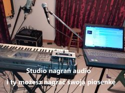 Recording studio with keyboard and laptop set up for recording.