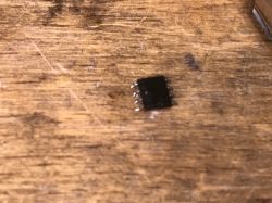 Integrated Circuit on Table Small integrated circuit on a wooden table.