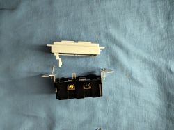 Separate parts of an electrical switch on a blue background.