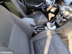 Interior of a Ford car showing front seats, center console, and dashboard.
