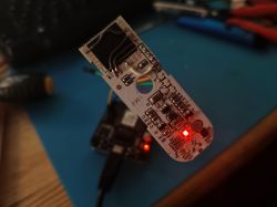 White PCB TH01 with Sensirion SHT30 sensor, glowing red LED.