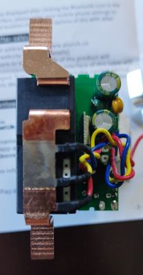 Internal view of an electronic module with visible components and wiring.